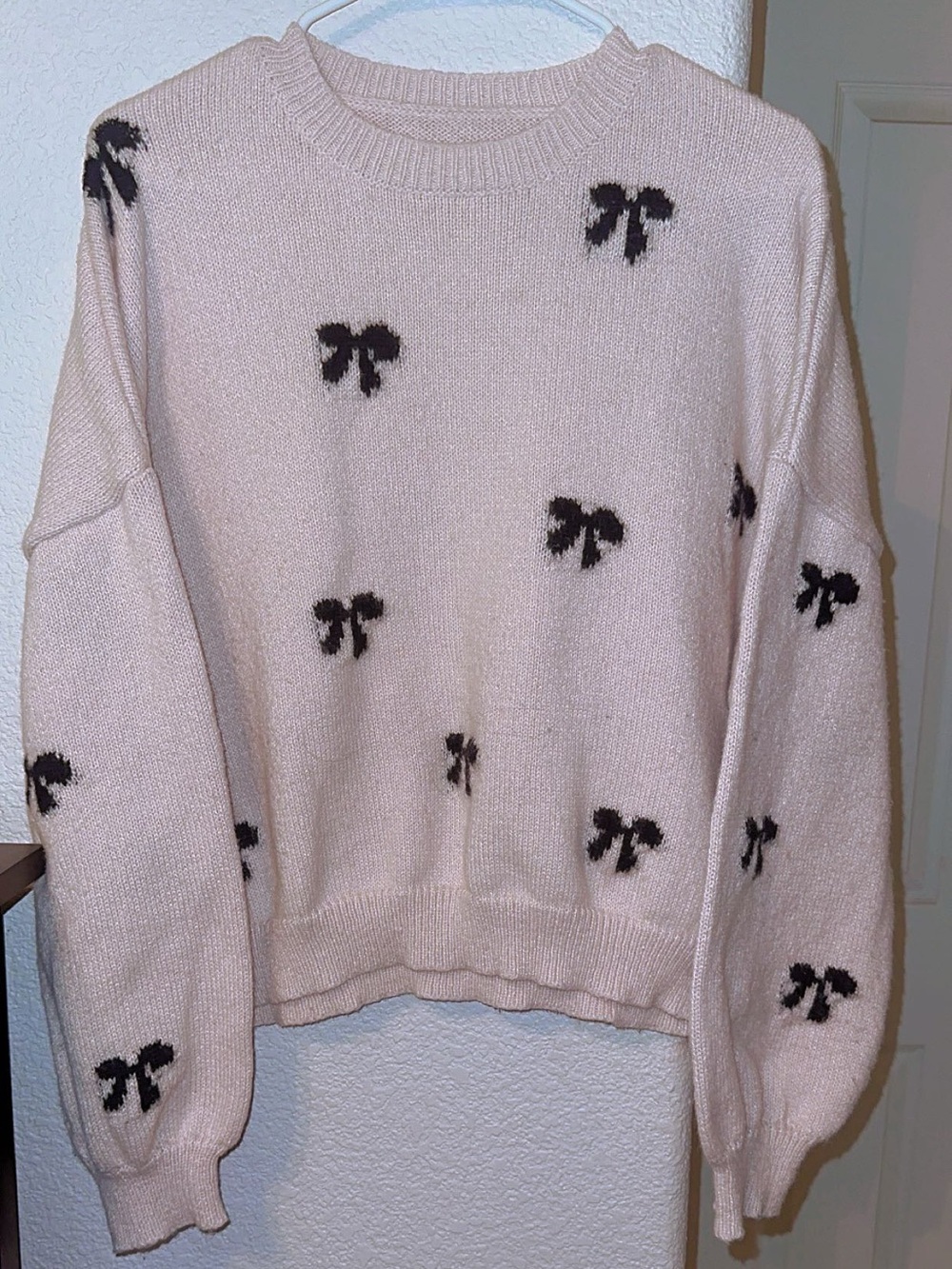 Black Bow Pattern on Cream Cropped Crewneck Sweater